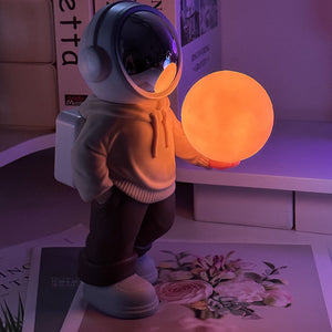 Holding The Romantic Moon (Beige Top + Brown Pants) Creative Astronaut Bluetooth Speaker With 3D Starry Sky Lighting Por